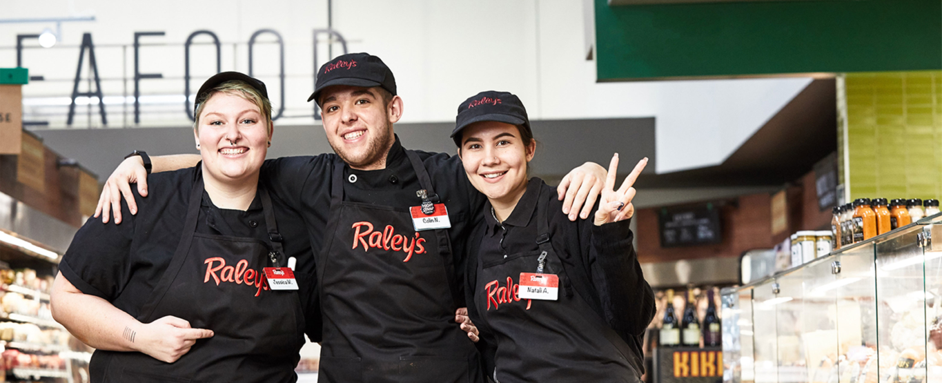 Three Raley's team members smiling.