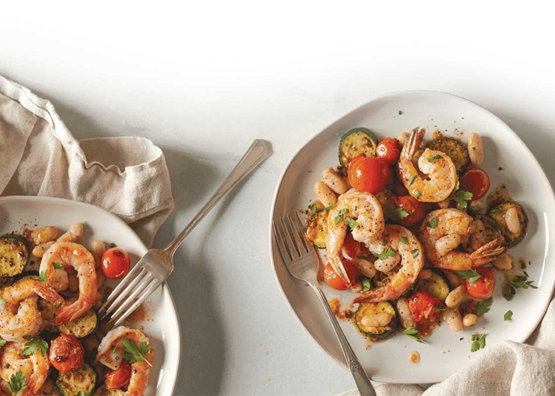 Image contains two plates of seafood